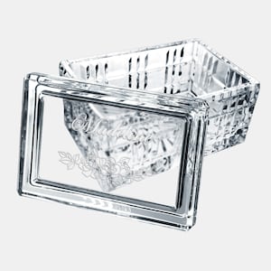 May include: A clear glass keepsake box with a hinged lid. The lid has an etched design of a floral motif and the name "Madeline".