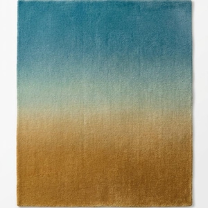 May include: A rectangular rug with a colour gradient. The top section is teal blue, fading into a light green, and then to a golden brown at the bottom. The rug has a soft, plush texture.