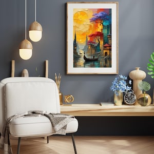 May include: A framed art print depicting a colorful cityscape with a boat on the water. The artwork features a vibrant sunset, buildings, and trees in shades of orange, red, purple, and blue. The print is displayed on a dark gray wall.