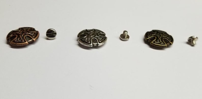 May include: Three metal Celtic knot buttons with screws. The buttons are in copper, silver, and antique gold.