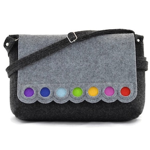 May include: A gray felt crossbody bag with a flap closure and a colorful rainbow of felt circles on the bottom edge.