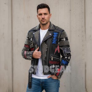 May include: Black leather jacket with silver studs and patches. The jacket features a classic biker style with a notched collar, asymmetrical zipper, and multiple pockets. Patches with text and lightning bolt designs are visible.