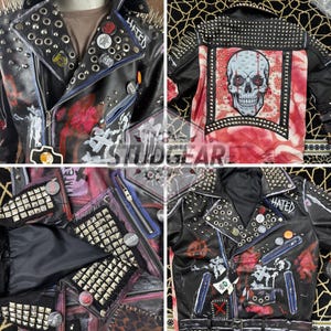 May include: A black leather motorcycle jacket featuring silver metal studs, spikes, and various circular pins. The jacket is decorated with red and white paint splatters, a large skull graphic on the back, and the word HATED printed on the collar.