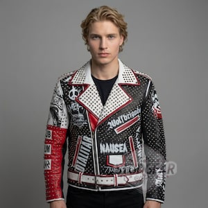 May include: Black leather jacket with white and red accents, covered in silver studs. The jacket features various patches and text, including "Wolfbrigade" and "Nausea". A white belt completes the look. A bold fashion statement.
