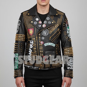 May include: Black leather jacket with gold studs and spikes. The jacket features multiple patches and pins, including the words "Vampire" and "Pain Gang". The jacket has a classic biker style with a notched collar and asymmetrical zipper.