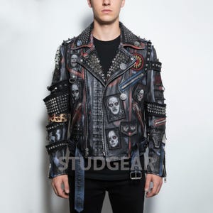 May include: A black leather jacket with a studded collar and patches featuring skull and zombie graphics. The jacket has multiple zippers, a belt, and the word "STUDGEAR" printed on the front.