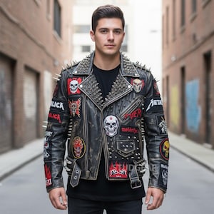 May include: Black leather jacket with silver spikes on the shoulders and collar. The jacket features multiple patches with skull and band logos. The jacket has a distressed look and a buckle closure.