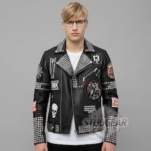 May include: Black leather jacket with silver stud accents, patches, and zippers. Features a skull graphic, the word "PUNK", and the number "13". The jacket has a studded collar and cuffs.
