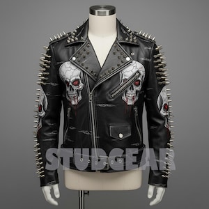 May include: Black leather jacket with silver spikes on the shoulders and sleeves. The jacket features a skull graphic with red eyes and blood dripping down. The jacket has a zipper closure and a belt at the waist.