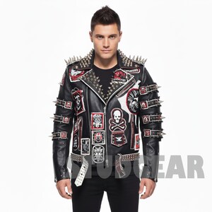 May include: Black leather jacket with silver spikes on the shoulders and sleeves. The jacket features multiple patches with skull and crossbones and other graphics. A white belt with silver studs completes the look.