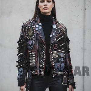May include: Black and red leather jacket with silver studs and spikes. The jacket features patches with skull and other designs, along with the number 13. The jacket has a classic biker style.