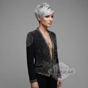 Close up texture of full grain leather with silver cone studs and UV printed finish