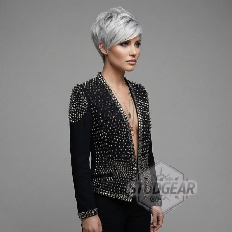 Close up texture of full grain leather with silver cone studs and UV printed finish