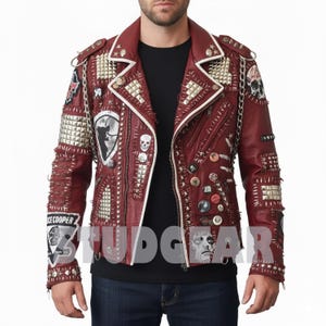 May include: A burgundy leather jacket with white trim, adorned with silver studs, patches, and pins. The jacket features multiple zippers, a chain detail, and the text "STUDGEAR".