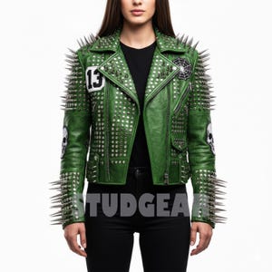 May include: Green leather jacket with silver studs and long silver spikes. The jacket features a skull patch, a spiderweb patch, and the number 13. The word "STUDGEAR" is printed on the jacket.