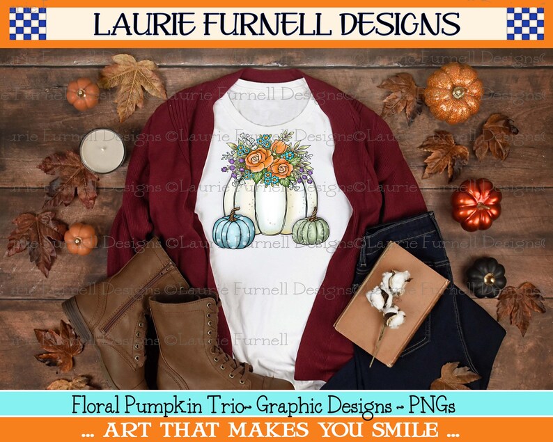 May include: A white t-shirt with a graphic design of three pumpkins with fall floral accents. The pumpkins are white, teal, and green. The text "Floral Pumpkin Trio - Graphic Designs - PNGs" is at the bottom of the image. The text "... ART THAT MAKES YOU SMILE ..." is below the first line of text.