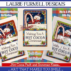 May include: Three Christmas card designs featuring a snowman holding a candy cane. Each card has a red, green, and white plaid background and says "Wishing You A Hot Cocoa Christmas!" The cards are packaged in cellophane bags and are ready to be given as gifts.