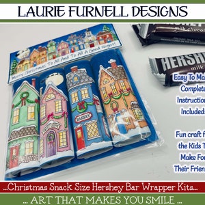 May include: A set of three printable Christmas Hershey bar wrappers featuring a winter village scene with houses, snow, and a moon. The wrappers are labeled "Sweet Shoppe", "Bakery", and "Merry Christmas To All And To All A Good Night!"