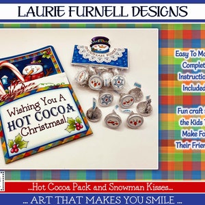 May include: A festive Christmas craft kit featuring a printable design for a hot cocoa pack and snowman kisses. The design includes a snowman holding a candy cane and the text "Wishing You A HOT COCOA Christmas!" The kit also includes instructions for making the craft.