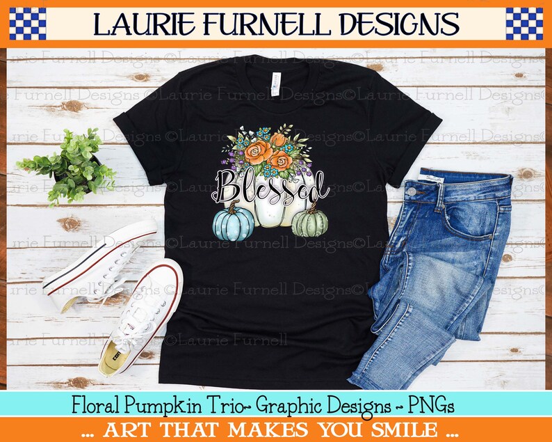 May include: Black t-shirt with a graphic design of three pumpkins with floral accents and the word "Blessed".
