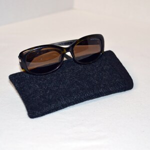 May include: A pair of brown tortoise shell sunglasses with brown lenses in a black felt case.