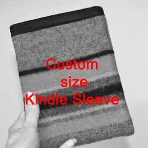 May include: A gray and black striped Kindle sleeve with the text "Custom size Kindle Sleeve" in red.