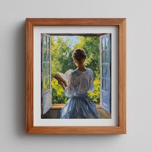 May include: A framed painting depicts a person reading a book by an open window. The person is wearing a light blue dress, and the window overlooks lush green foliage. The frame is made of wood.