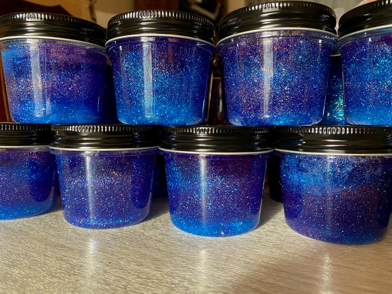 8 jars filled with purple and blue glitter jelly soap