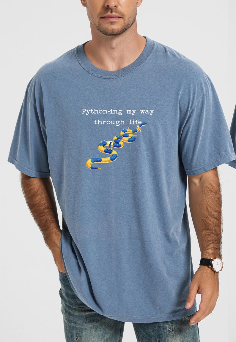 May include: Blue t-shirt with the text "Python-ing my way through life" above a graphic of yellow and blue inflatable tubes. The shirt is a solid blue color and has short sleeves.