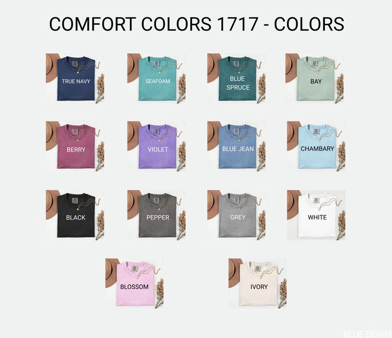 May include: A selection of Comfort Colors 1717 t-shirts in various colors, including True Navy, Seafoam, Blue Spruce, Berry, Violet, Blue Jean, Black, Pepper, Grey, White, Blossom, and Ivory. Each shirt is displayed with a necklace and a hat.