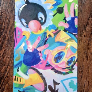 May include: A vibrant art card with cartoon characters in bright blues, pinks, yellows, and greens. The illustration includes musical notes and the artist's signature, "YOOMTAH". The card's design features large-eyed characters in dynamic poses.