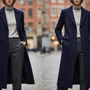 May include: A navy blue overcoat with a classic tailored design. The coat features a notched lapel, two front pockets, and a two-button closure. The model is wearing a gray turtleneck and gray trousers. The coat is a long length, reaching the ankles.
