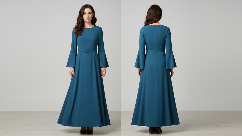 Pode incluir: Vestido longo azul-petr&oacute;leo com mangas compridas e largas e cinto a condizer. O vestido tem decote redondo e saia fluida. A imagem mostra o vestido pela frente e por tr&aacute;s, destacando o seu design e caimento. Adequado para ocasi&otilde;es formais.