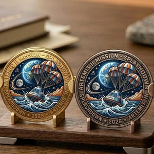 May include: A white ceramic mug with a black handle and the text "But First, Coffee" in a bold, black font. The mug is set against a blurred background, suggesting a cozy setting.