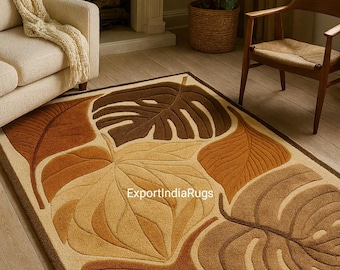 May include: A rectangular area rug with a leaf design in shades of brown and beige. The rug features large, stylized leaves with varying textures and tones, creating a natural, organic aesthetic. The rug is bordered with a darker brown.