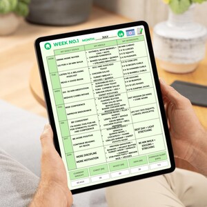 May include: A digital tablet displaying a green and white weekly workout and meal plan for July. The plan includes daily goals, meal suggestions, and workout routines. The tablet is held by a person.