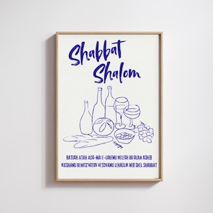 May include: A framed print with the words "Shabbat Shalom" in blue script. Below, a blue line drawing depicts wine bottles, glasses, bread, olives, and grapes. The print includes Hebrew text at the bottom.