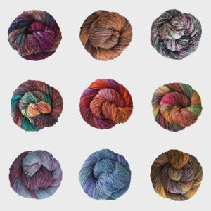 May include: Nine skeins of multi-coloured yarn in a variety of hues, including purple, brown, green, and blue. The yarn is arranged in a grid pattern, each skein tightly wound into a circular shape. The yarn appears soft and textured, suitable for knitting or crochet projects.
