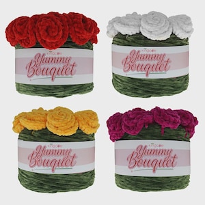 May include: Four colorful yarn bouquets. Each bouquet has a different color of yarn flowers: red, white, yellow, and magenta. The bouquets are wrapped in green yarn and have a label that says "Yummy Bouquet".