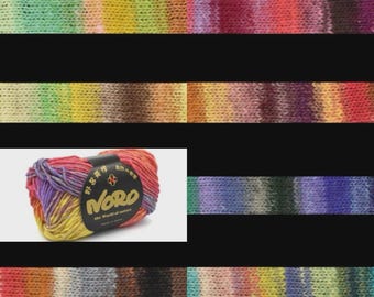May include: Close-up of colorful yarn skein and knitted swatches. The yarn is a blend of vibrant colors, including yellow, orange, red, purple, and green. The swatches display the yarn's color transitions. The label on the yarn ball reads "Noro".