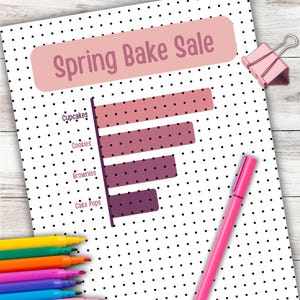 May include: A white paper with a black polka dot pattern and the text "Spring Bake Sale" in a pink banner. A bar graph shows the popularity of cupcakes, cookies, brownies, and cake pops. A pink pen and a set of colourful markers are also visible.