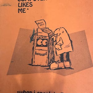 May include: Orange poster with a cartoon illustration of a computer and a person. The computer has a face and a paper that says "RIGHT ON!!". Text at the top says "MY COMPUTER LIKES ME". The bottom text says "when I speak in BASIC".