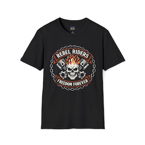May include: Black t-shirt with a graphic design featuring a skull with flames, pistons, and the words "REBEL RIDERS FREEDOM FOREVER" in a circular design. The design is in shades of orange, white, and gray.