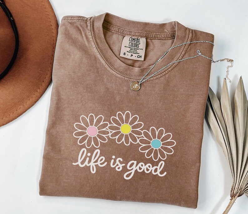 May include: A trio of ceramic mugs with a speckled, matte finish in cream, light grey, and dark grey. Each mug features a simple, minimalist design, ideal for tea or coffee.