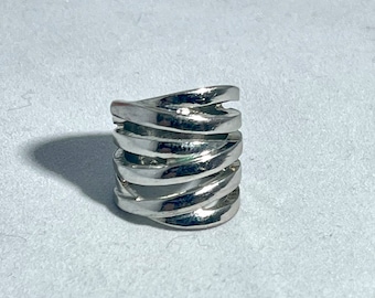 May include: A silver ring with a unique design featuring multiple bands that twist and turn around the finger.