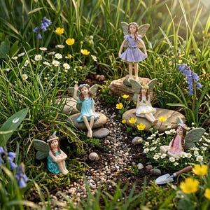 May include: A collection of fairy figurines in a garden setting. The fairies are dressed in various pastel colors, with delicate wings and floral accents. They are posed among rocks, flowers, and greenery, creating a whimsical scene.