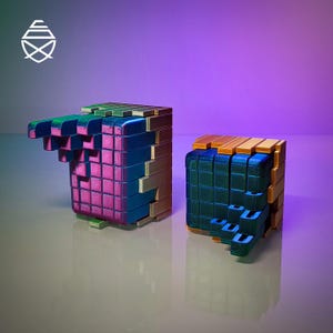 May include: Two 3D-printed puzzle cubes with shifting segments. The left cube features a metallic blue and magenta grid with gold-toned side panels. The right cube displays a dark teal and green grid with gold-toned side panels. A white logo is visible.