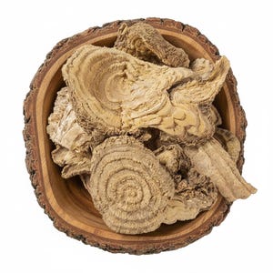 May include: A wooden bowl filled with dried, beige-colored root pieces. The bowl has a natural, rough bark edge. The root pieces have a variety of shapes and textures, some with concentric circles.
