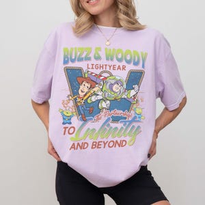 May include: A white ceramic mug with a black handle and the text "But First, Coffee" in a black, handwritten-style font. The mug is on a white surface.