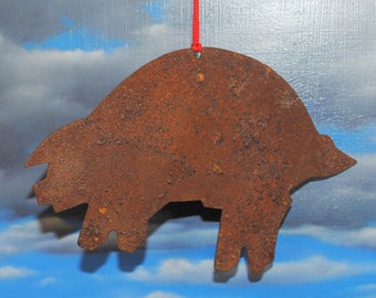 Christmas ornament of farm animal "the pig" cut from rusty metal for your country tree